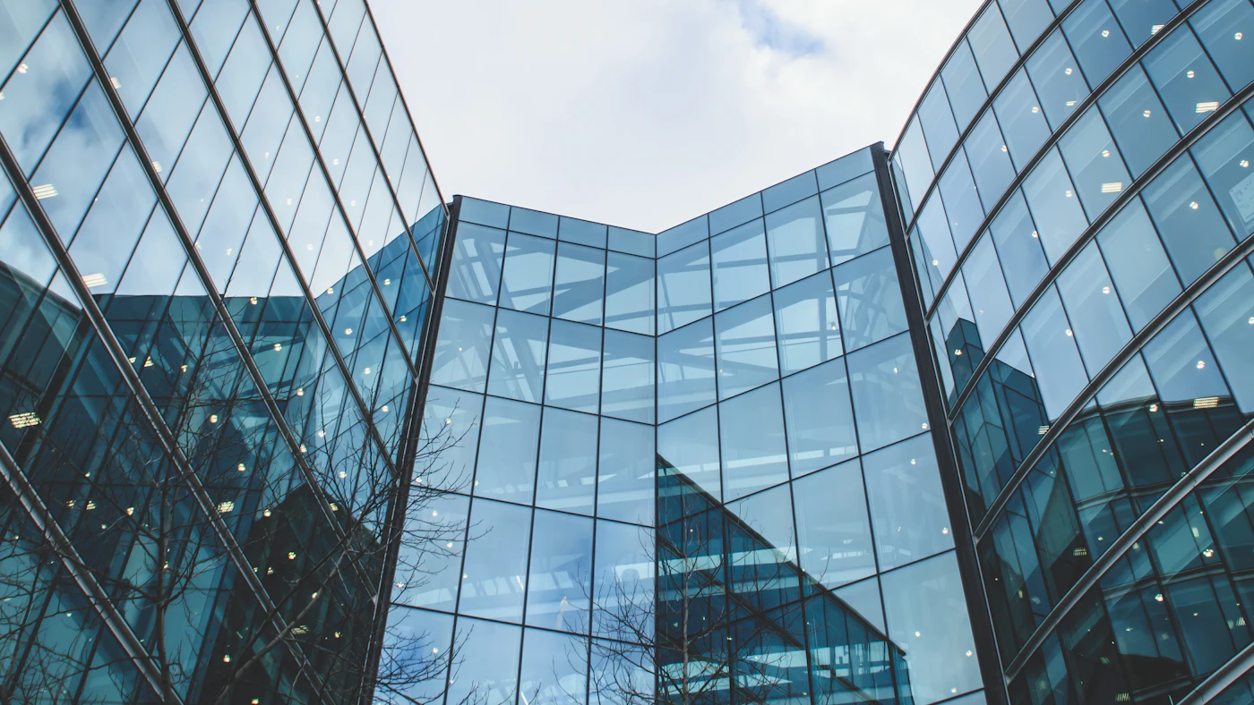 Glass office buildings reflecting the sky